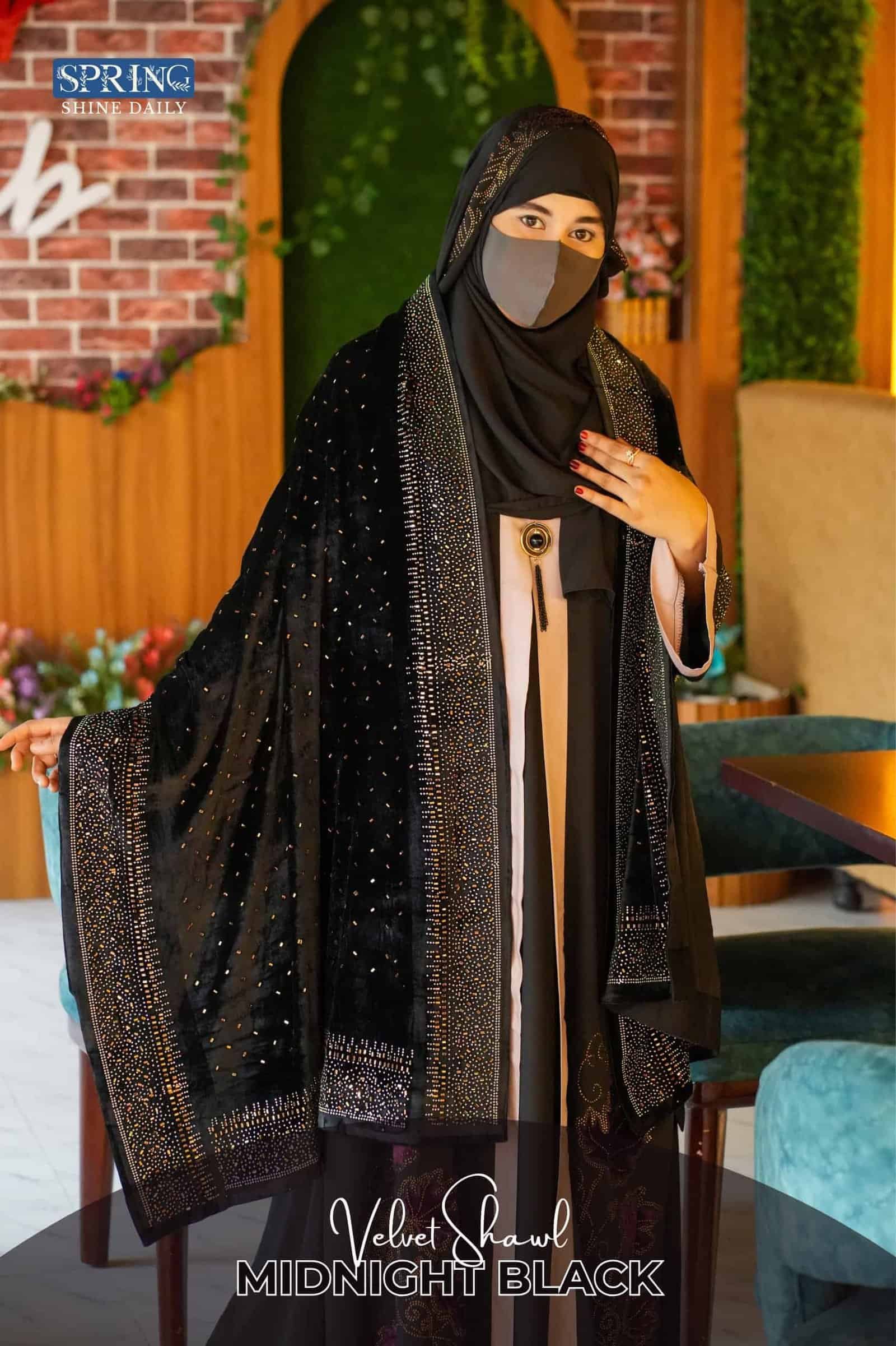 Luxurious black velvet shawl with intricate embellishments for elegant fashion.