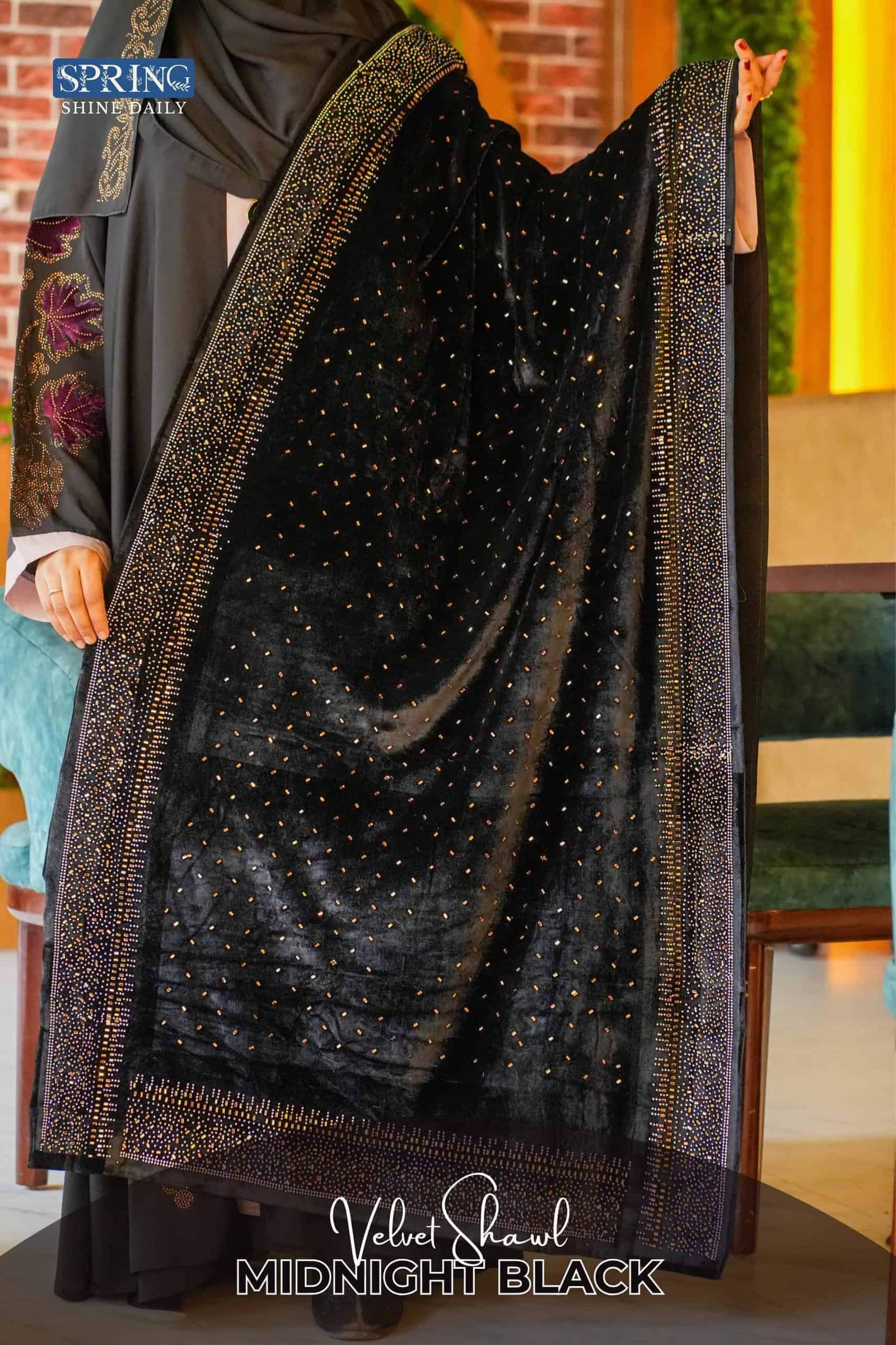 Luxurious black velvet shawl with intricate gold embellishments, perfect for elegant occasions.